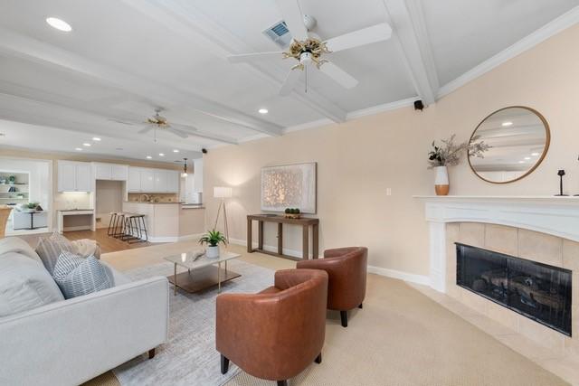 2034 Oak Glen Dr, Mcgregor, TX 76657 - living room featuring ceiling fan, recessed lighting, beamed ceiling, a tile fireplace, and baseboards