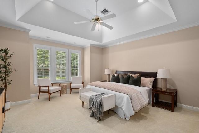 2034 Oak Glen Dr, Mcgregor, TX 76657 - bedroom featuring a raised ceiling, ornamental molding, light carpet, baseboards, and a ceiling fan