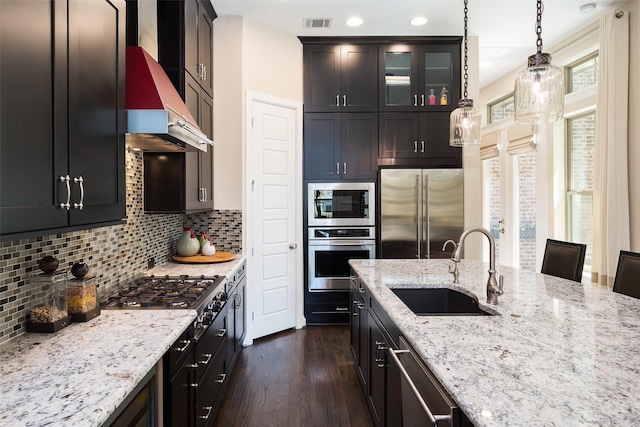 3703 Panalero Ln, Dallas, TX 75209 - kitchen with built in appliances, a sink, dark wood-style flooring, light stone countertops, and glass insert cabinets
