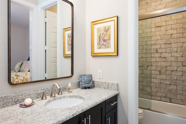 3703 Panalero Ln, Dallas, TX 75209 - bathroom with vanity, shower / bath combination with glass door, and toilet