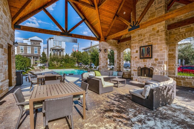 3703 Panalero Ln, Dallas, TX 75209 - view of patio with an outdoor living space with a fireplace, an outdoor pool, outdoor dining area, and a gazebo