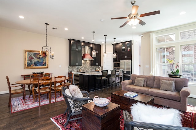 3703 Panalero Ln, Dallas, TX 75209 - living room featuring dark wood-type flooring, a ceiling fan, recessed lighting, baseboards, and a chandelier