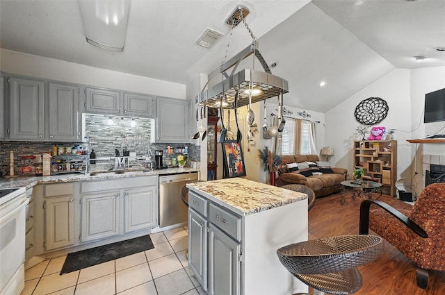 3217 Whatley Dr, Garland, TX 75043 - kitchen featuring stainless steel dishwasher, gray cabinets, open floor plan, tasteful backsplash, and white electric range oven