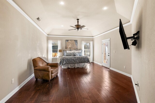 bedroom featuring crown molding, visible vents, wood-type flooring, and vaulted ceiling
