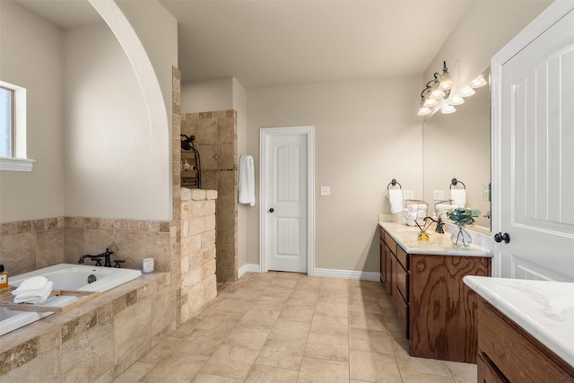 bathroom featuring vanity, a walk in shower, and a garden tub