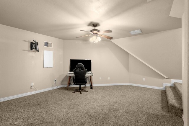 unfurnished office featuring visible vents, a ceiling fan, baseboards, and carpet floors