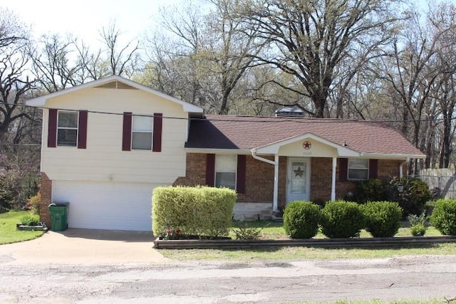view of front facade featuring brick siding, driveway, and an attached garage