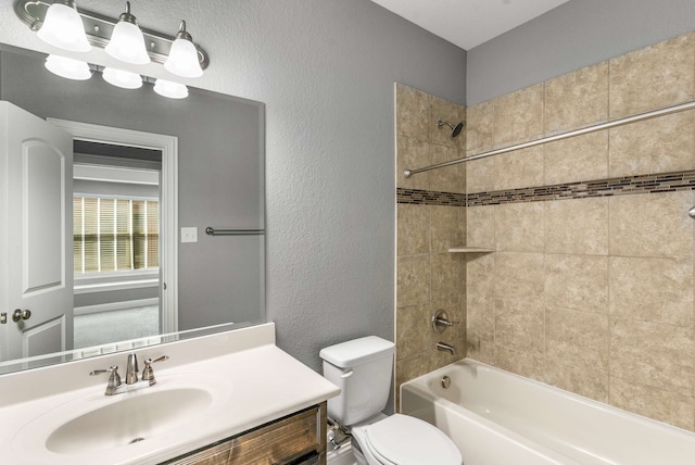 7813 Saint Clair Dr, Mckinney, TX 75071 - bathroom featuring toilet, vanity, a textured wall, and bathing tub / shower combination