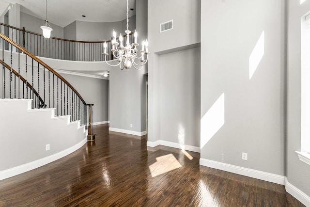 7813 Saint Clair Dr, Mckinney, TX 75071 - entryway with visible vents, baseboards, wood finished floors, a high ceiling, and a notable chandelier