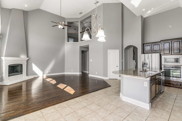 7813 Saint Clair Dr, Mckinney, TX 75071 - kitchen featuring open floor plan, arched walkways, and appliances with stainless steel finishes