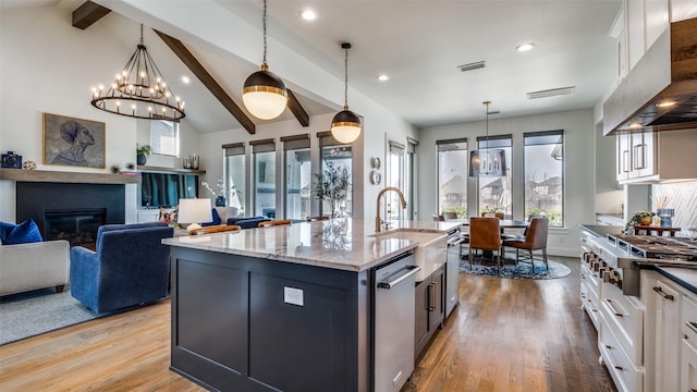 6023 Manderlay Dr, Frisco, TX 75034 - kitchen featuring stainless steel appliances, wall chimney exhaust hood, a sink, wood finished floors, and recessed lighting