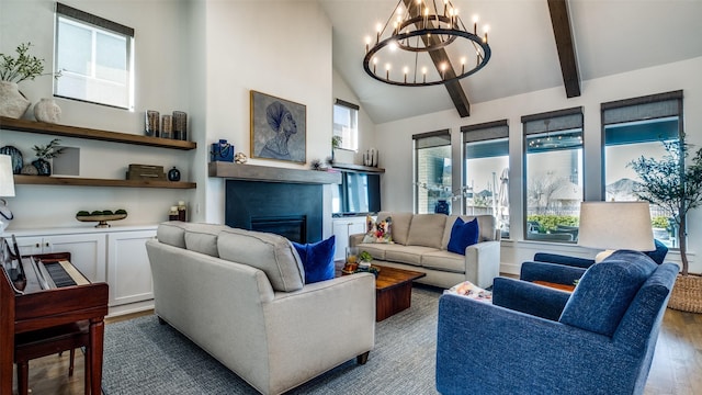 6023 Manderlay Dr, Frisco, TX 75034 - living area featuring a glass covered fireplace, a chandelier, wood finished floors, beamed ceiling, and healthy amount of natural light