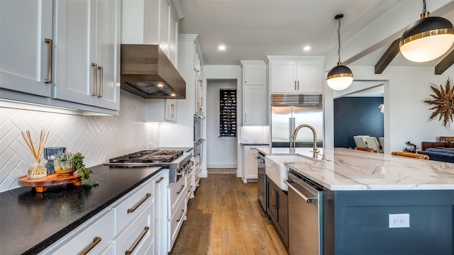 6023 Manderlay Dr, Frisco, TX 75034 - kitchen with a sink, appliances with stainless steel finishes, tasteful backsplash, wood finished floors, and white cabinetry