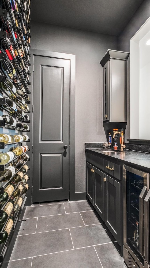 6023 Manderlay Dr, Frisco, TX 75034 - bathroom with beverage cooler, tile patterned flooring, and a sink