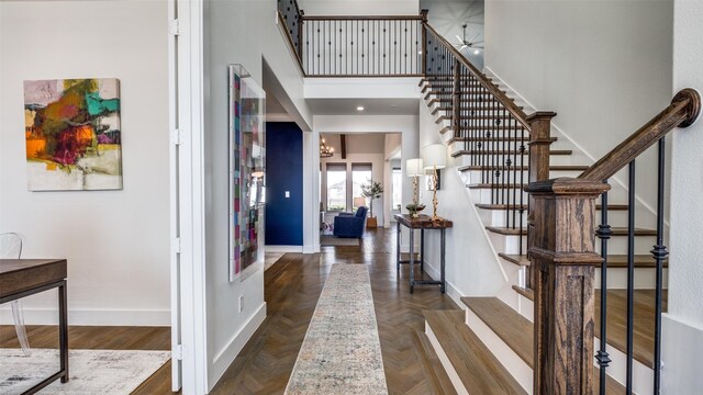 6023 Manderlay Dr, Frisco, TX 75034 - entryway with stairs, baseboards, a towering ceiling, a ceiling fan, and a chandelier