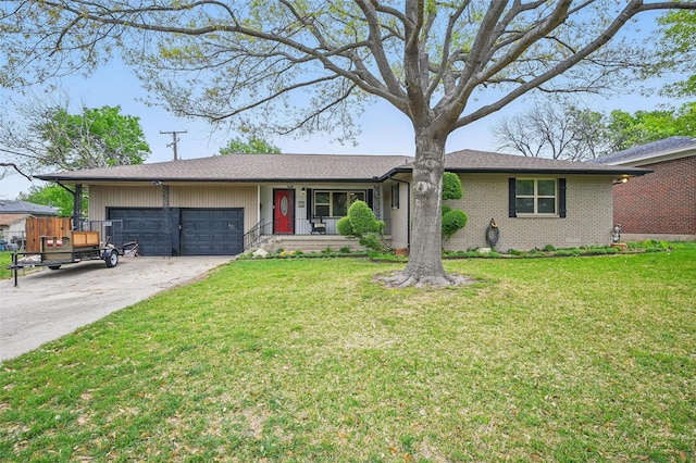 single story home featuring brick siding, an attached garage, a front lawn, and concrete driveway