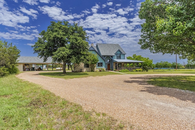1125 Old Airport Rd, Weatherford, TX 76087 - view of front facade with a trampoline, a front yard, stone siding, and curved driveway