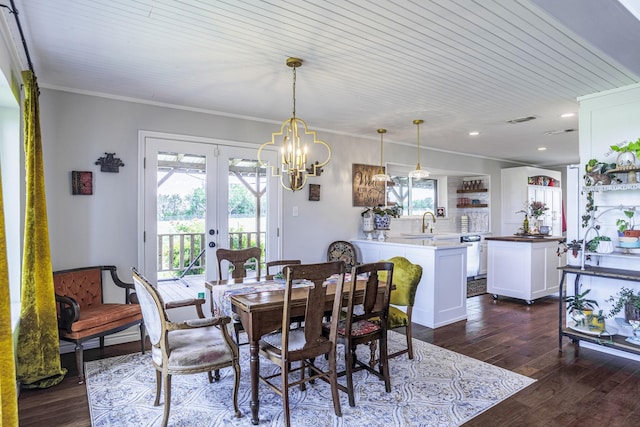 1125 Old Airport Rd, Weatherford, TX 76087 - dining space featuring recessed lighting, french doors, ornamental molding, dark wood finished floors, and a notable chandelier