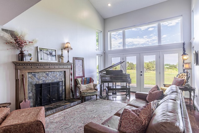 1125 Old Airport Rd, Weatherford, TX 76087 - living area featuring a wealth of natural light, a tile fireplace, high vaulted ceiling, and wood finished floors