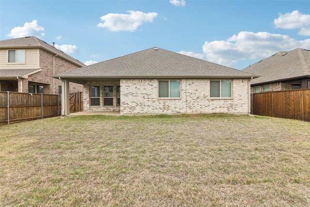 1236 Arrowwood Dr, Aubrey, TX 76227 - back of house featuring a fenced backyard, brick siding, and a yard