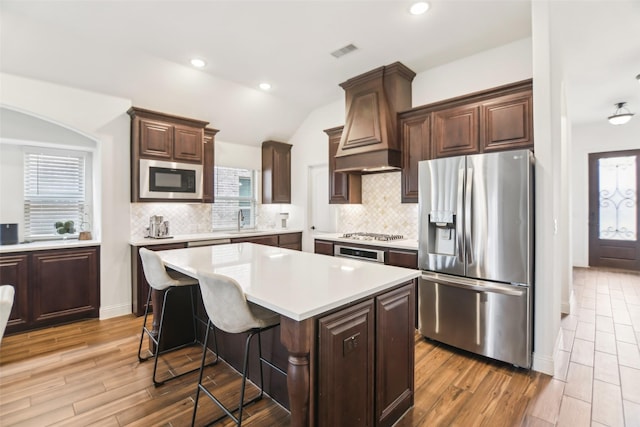 1236 Arrowwood Dr, Aubrey, TX 76227 - kitchen with light countertops, premium range hood, a sink, visible vents, and appliances with stainless steel finishes