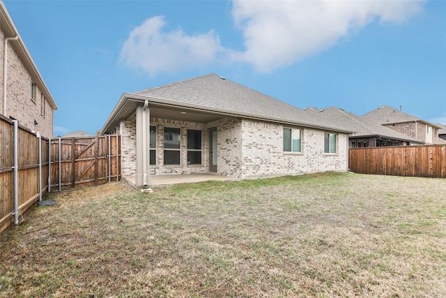 1236 Arrowwood Dr, Aubrey, TX 76227 - back of property featuring a fenced backyard, a patio, brick siding, and a yard
