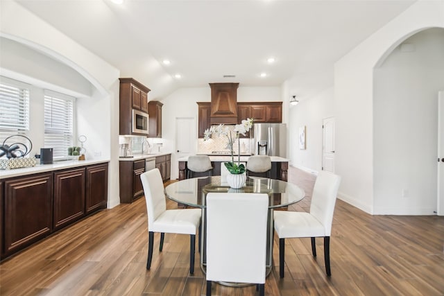 1236 Arrowwood Dr, Aubrey, TX 76227 - dining space with recessed lighting, arched walkways, lofted ceiling, and dark wood finished floors