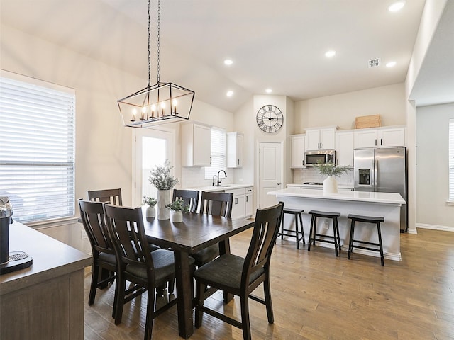5024 Wilder Ave, Celina, TX 76227 - dining area with vaulted ceiling, wood finished floors, a chandelier, recessed lighting, and baseboards