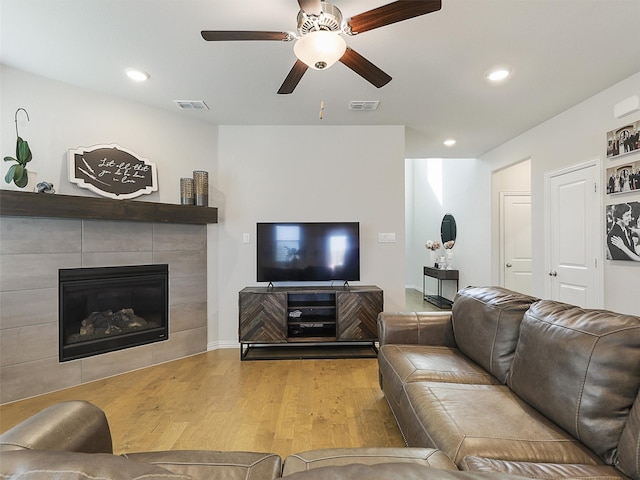 5024 Wilder Ave, Celina, TX 76227 - living room with wood finished floors, a ceiling fan, a tile fireplace, and recessed lighting