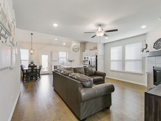 5024 Wilder Ave, Celina, TX 76227 - living area with a ceiling fan, baseboards, wood finished floors, a fireplace, and recessed lighting