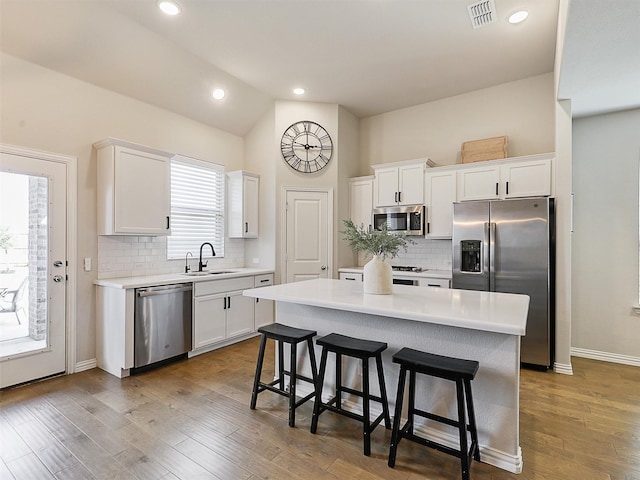 5024 Wilder Ave, Celina, TX 76227 - kitchen featuring stainless steel appliances, a sink, white cabinetry, light countertops, and tasteful backsplash