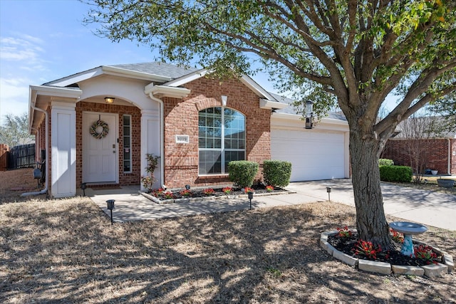 ranch-style house featuring driveway, brick siding, and an attached garage