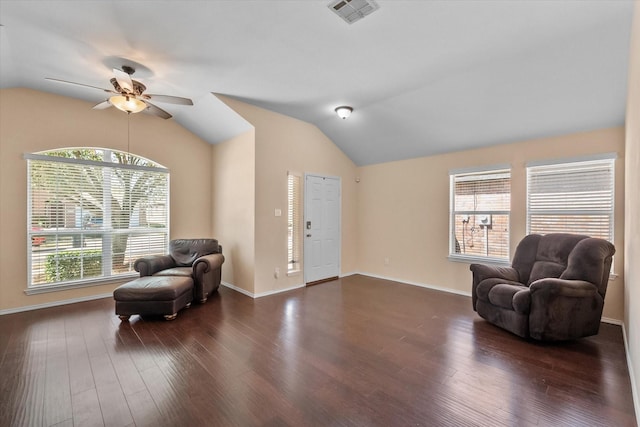 sitting room featuring dark wood finished floors, vaulted ceiling, visible vents, and ceiling fan