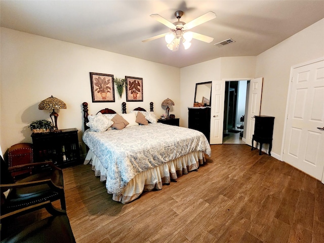 bedroom featuring visible vents, ceiling fan, and wood finished floors