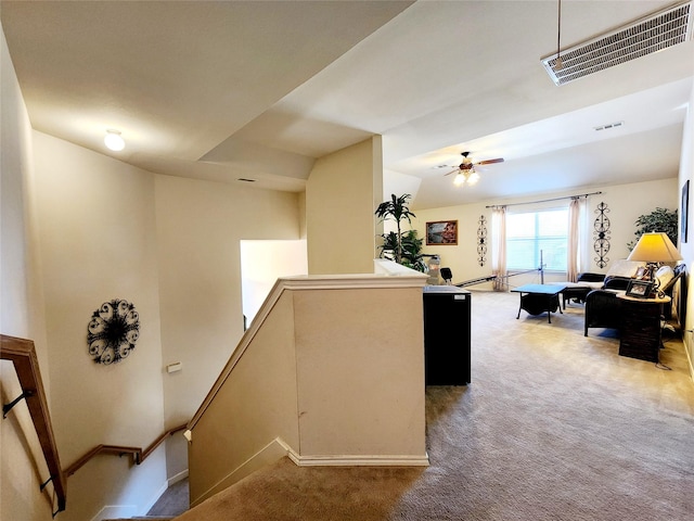 kitchen featuring baseboards, visible vents, ceiling fan, and carpet floors