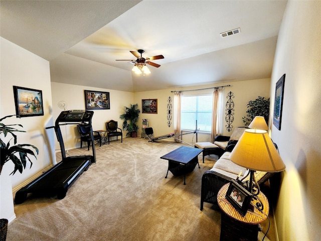 interior space featuring visible vents, ceiling fan, and carpet floors