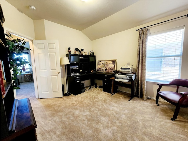 home office with light carpet and vaulted ceiling
