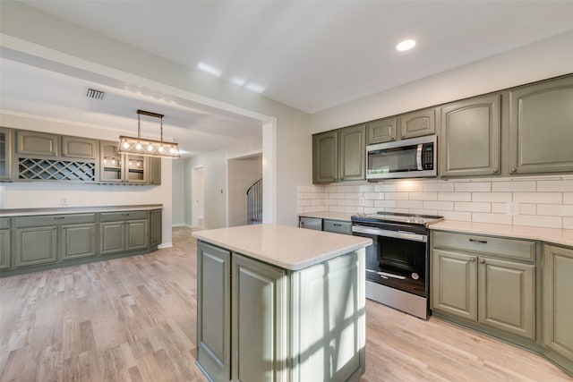 kitchen with green cabinetry, visible vents, light countertops, and stainless steel appliances