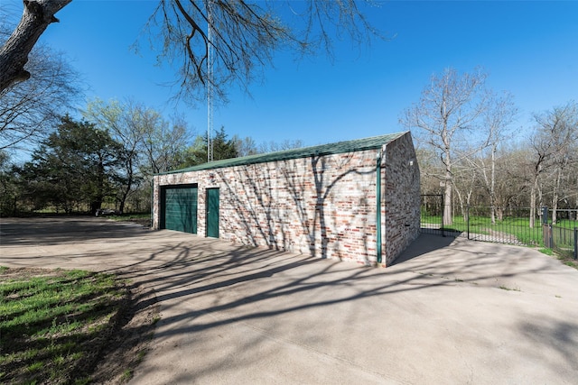 detached garage with driveway and fence