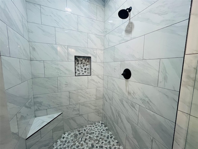 bathroom featuring tiled shower