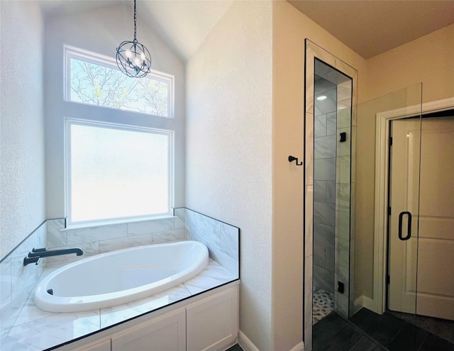 full bath with a wealth of natural light, a tile shower, and a garden tub