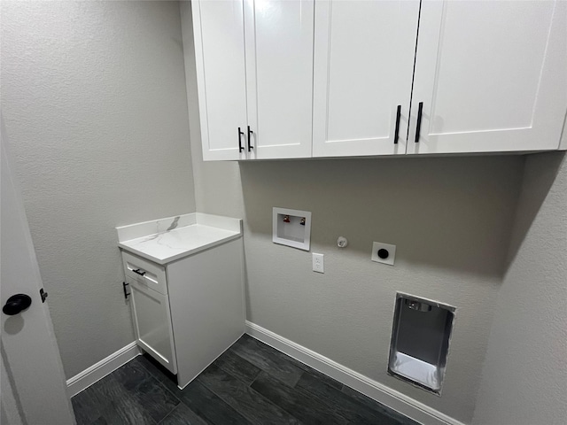 washroom with hookup for an electric dryer, baseboards, hookup for a washing machine, and cabinet space
