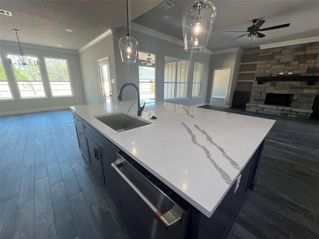 kitchen with ceiling fan with notable chandelier, stainless steel dishwasher, dark wood-style flooring, a sink, and open floor plan