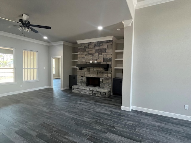 unfurnished living room featuring crown molding, a fireplace, a ceiling fan, and baseboards