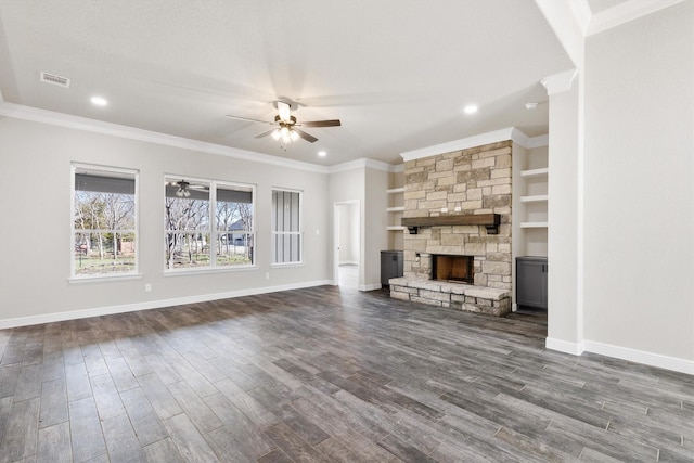 unfurnished living room with dark wood-type flooring, ceiling fan, baseboards, and a fireplace