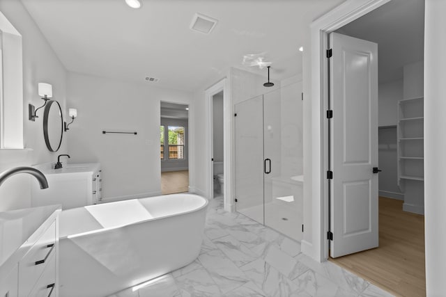 1330 Caleb Rd, Van Alstyne, TX 75495 - full bathroom featuring a stall shower, vanity, marble look tiles, a soaking tub, and toilet