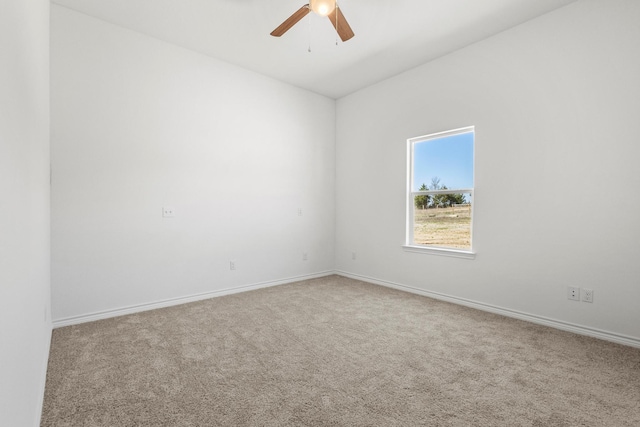 empty room featuring baseboards, a ceiling fan, and carpet flooring