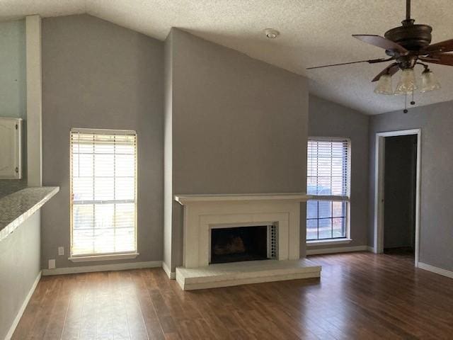 4220 Staghorn Cir N, Fort Worth, TX 76137 - unfurnished living room featuring vaulted ceiling, wood finished floors, a ceiling fan, baseboards, and a textured ceiling