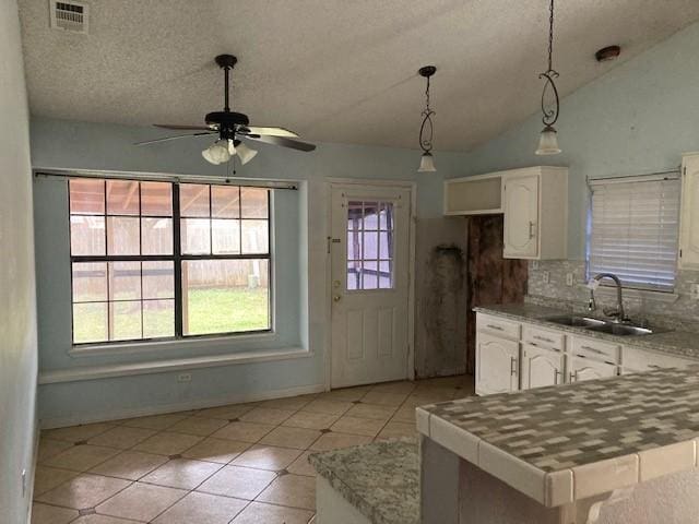 4220 Staghorn Cir N, Fort Worth, TX 76137 - kitchen featuring ceiling fan, white cabinetry, light tile patterned floors, a sink, and tasteful backsplash