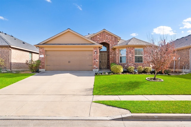 single story home with brick siding, a front yard, driveway, and a garage